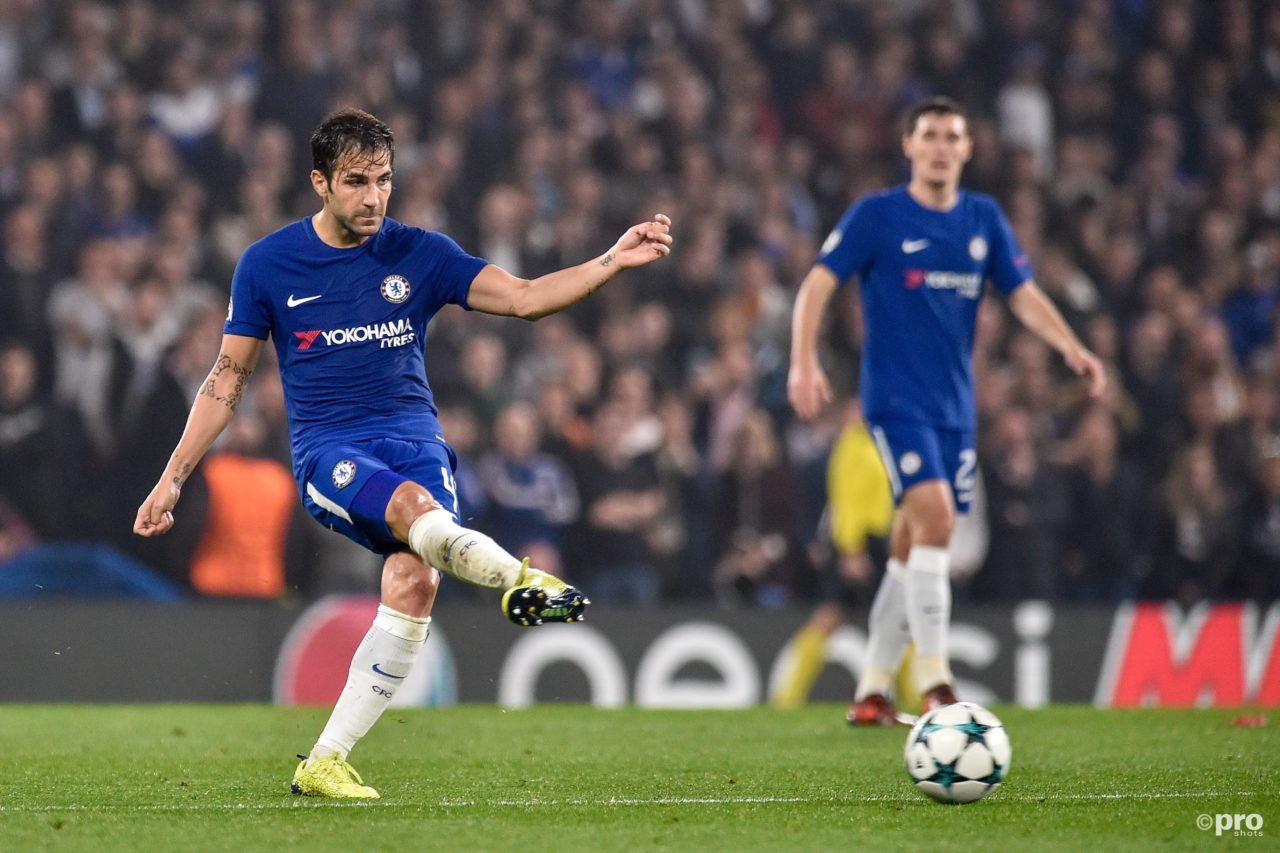 Fabregas passing a ball in Chelsea jersey with crowd in the background