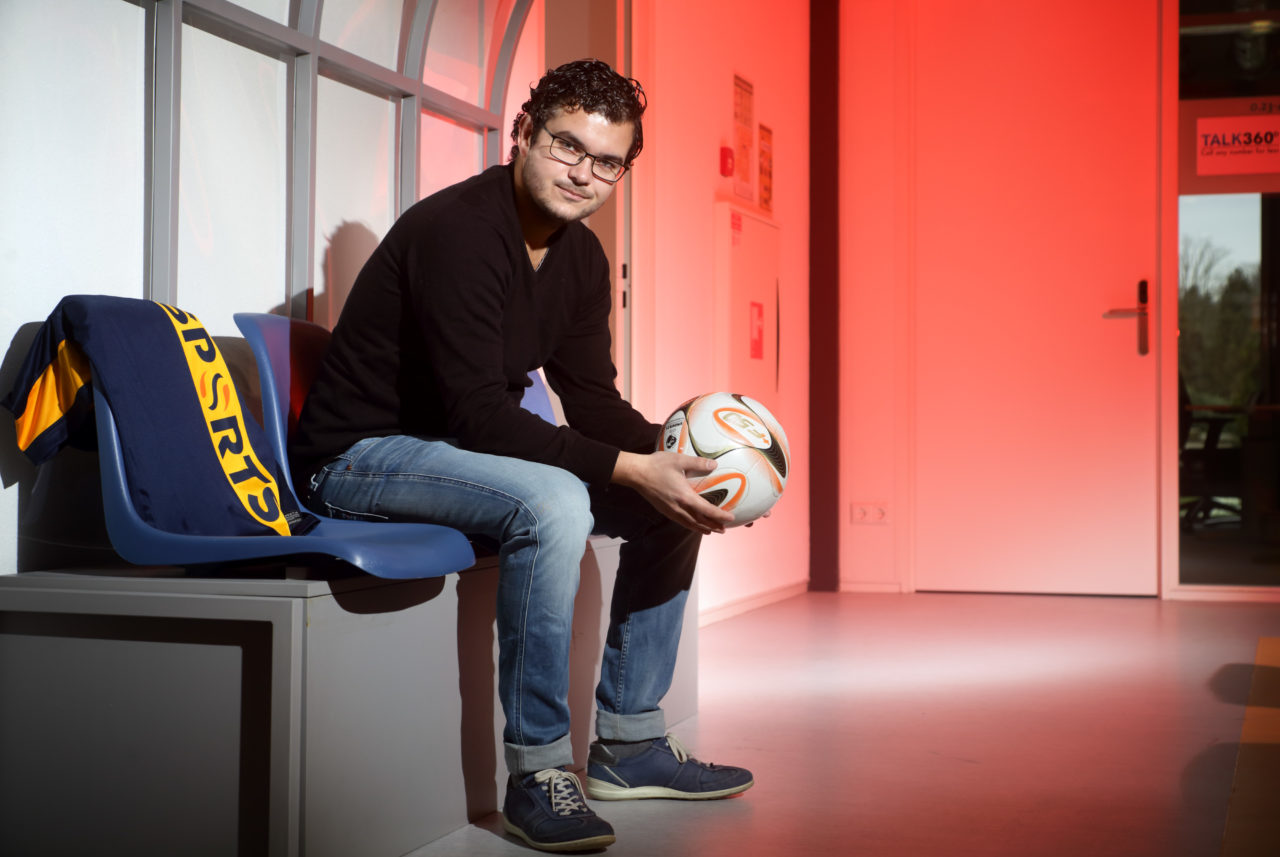 Image of SciSports' Founder Giels Brouwer holding a ball in a dug-out at SciSports
