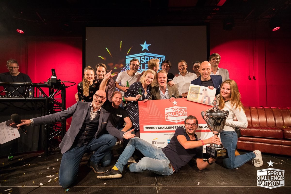 Image of SciSports' team celebrating at Sprout Challenger Night with cup